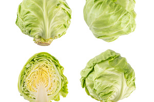 Young spring green raw cabbage, whole and cut, a Food & Drink Photo by Rimma