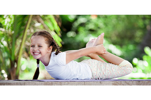 Child doing exercise on platform outdoors healthy lifestyle yoga girl
