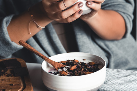 A young woman drinks morning coffee