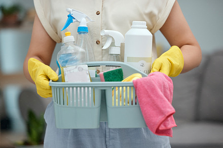 Woman, hands and detergent basket for cleaning, housekeeping or disinfection of dirt at home. Closeup of female cleaner holding container of chemical bottles, products or liquid tools of maid service, a Photo by Peopleimages.com