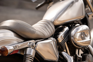 Close-up of a stylish motorcycle seat and chrome details, a Transportation Photo by AlyaAnd
