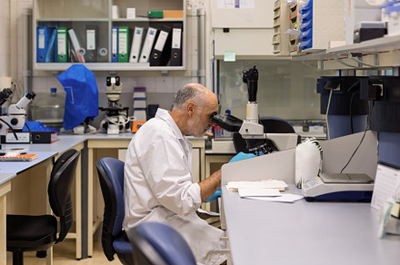 Scientist using a microscope in a mo, a Health & Medical Photo by Perpis