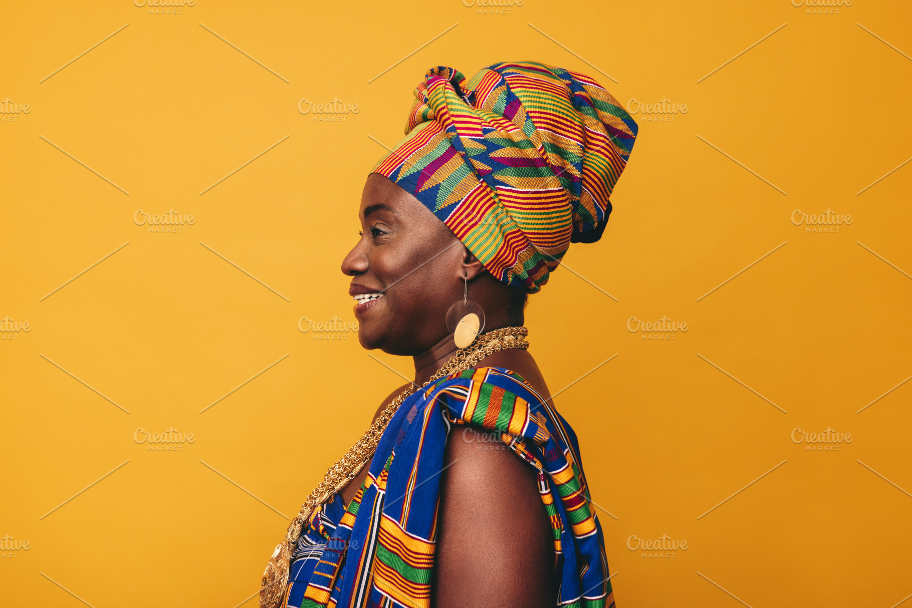 Happy African woman wearing cultural clothing in a studio, a Person Photo by Jacob Lund