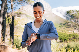 Cheerful woman checking pulse, a Sports & Recreation Photo by Artem Varnitsin