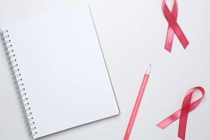 Woman arranging preventive checkup with pink ribbon visible, symbolizing breast, a Photo by matucha