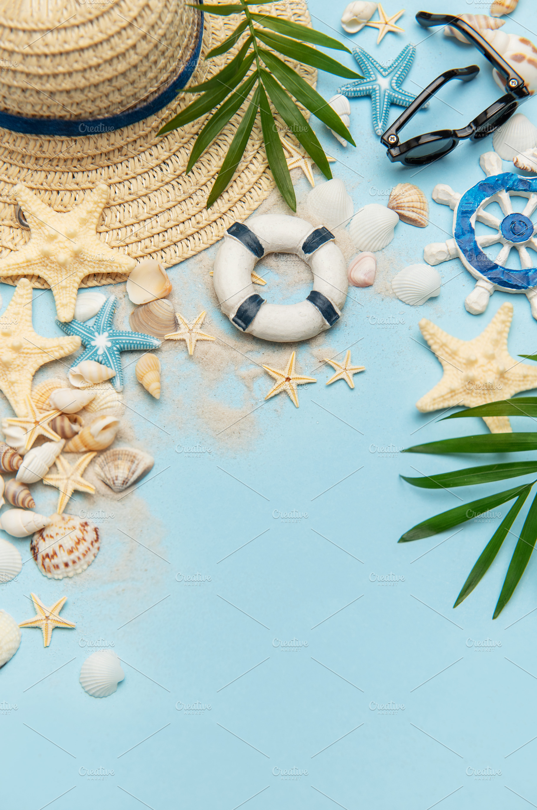 Summer vacation accessories creating a frame on blue background, a Holiday Photo by Olena Rudo
