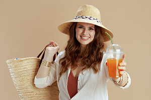 smiling 40 years old housewife in blouse and shorts on beige, a Person Photo by Alliance Images