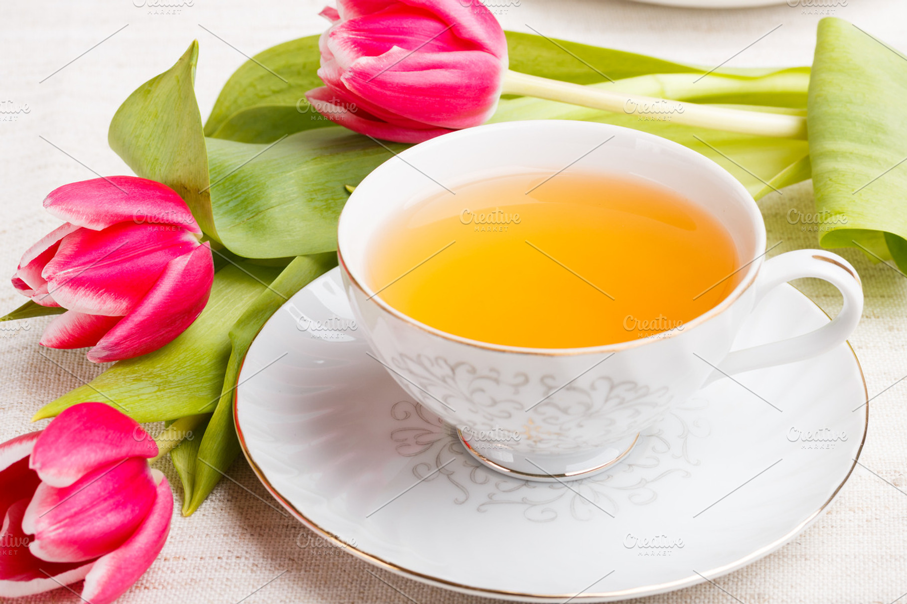 Cup of tea containing tea, table, and natural