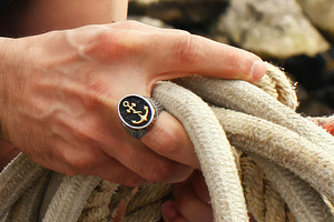 Sailor wearing a ring with an anchor while holding a rope, an Abstract Photo by Antonio Gravante Market