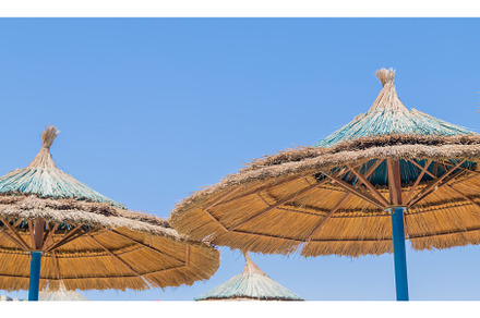Thatched umbrellas on the beach, a Nature Photo by yanadjana