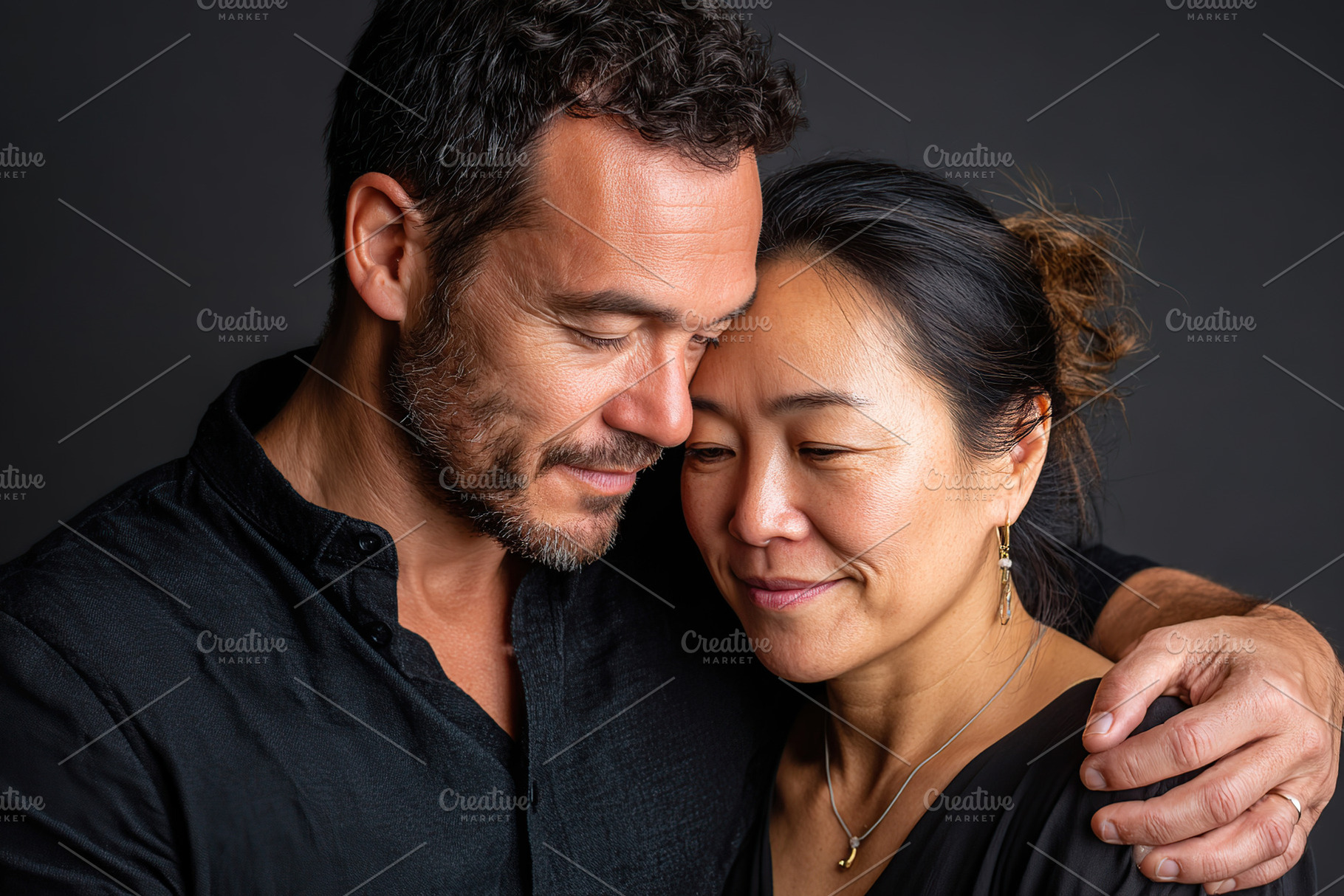 Couple embracing tenderly in a warm, intimate moment captured with a dark backg, a Photo by AlyaAnd