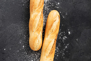 Two Fresh Baguettes with Flour on Dark Textured Surface, a Food & Drink Photo by Natalia Klenova's Shop