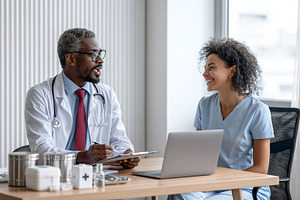 Doctor consulting with patient, a Health & Medical Photo by 7DesignLab