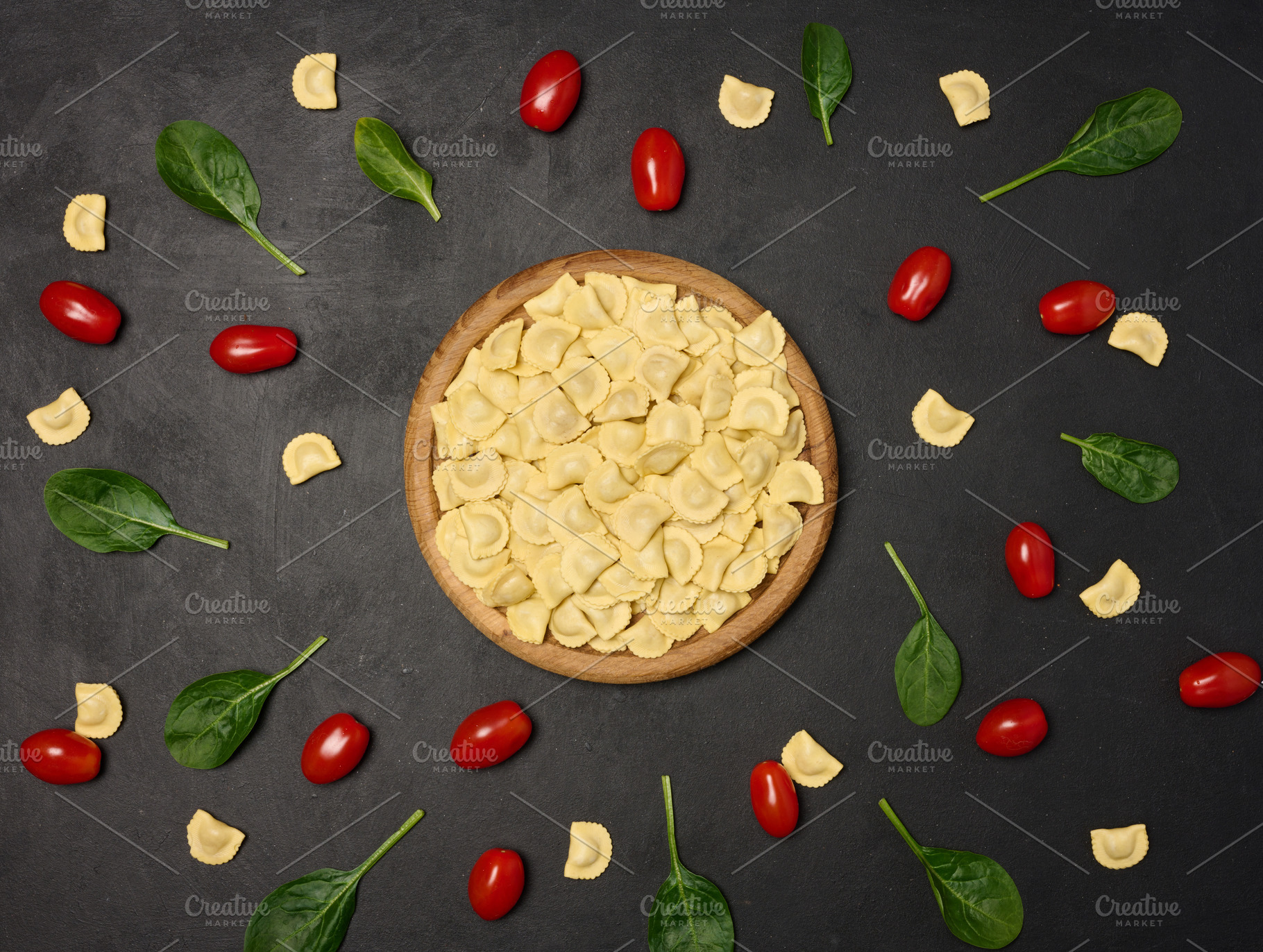 Uncooked tortellini pasta with fresh cherry tomatoes and spinach, a Food & Drink Photo by ndanko