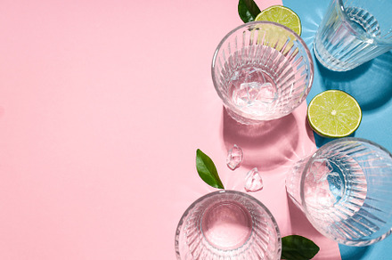 Glasses of water, lime, leaves and ice on two tone background, a Food & Drink Photo by AtlasStudio PRO