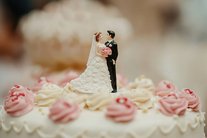 Bride and groom figurines adorn, a Photo by Pavel_design