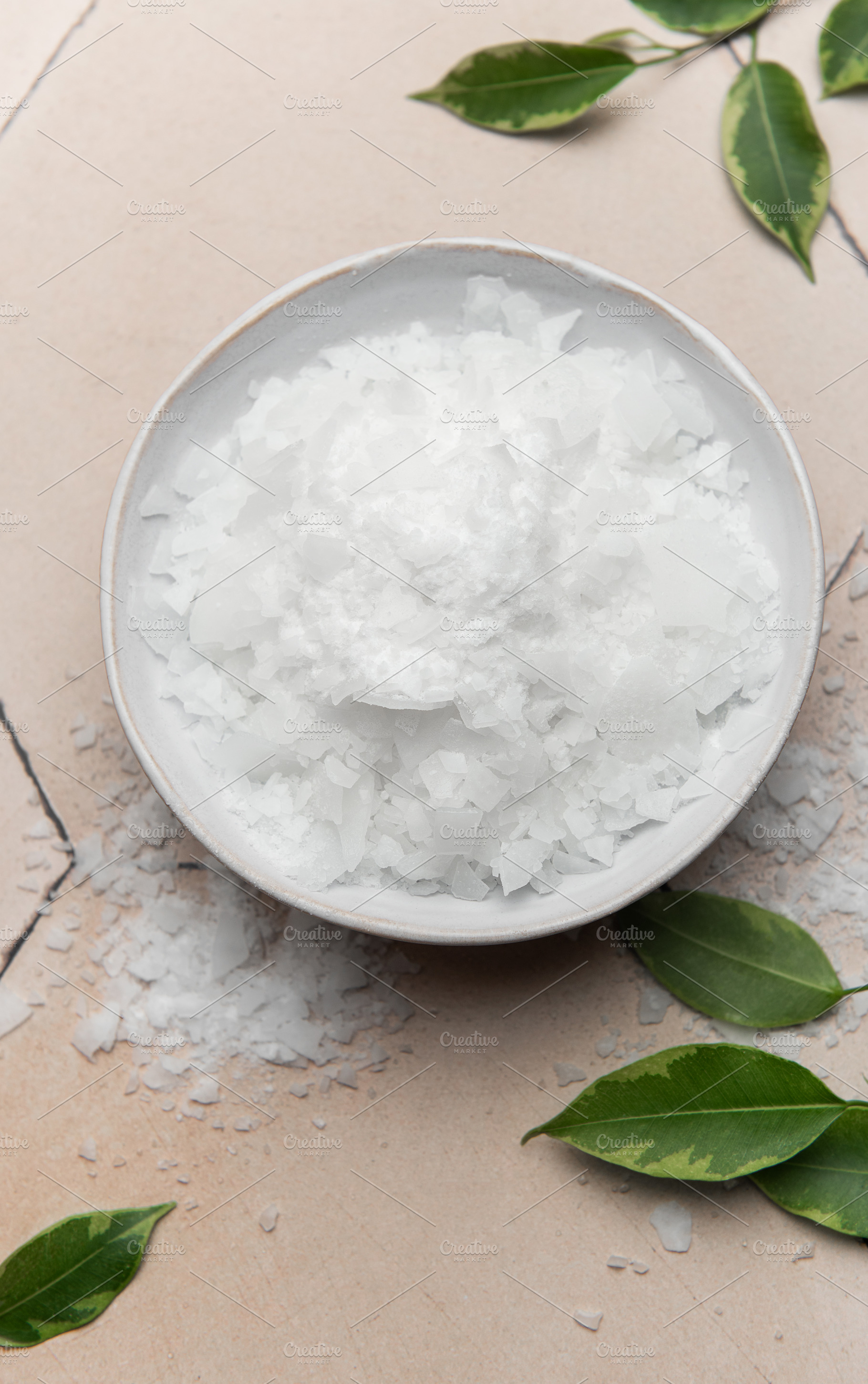 Magnesium chloride flakes in a bowl for spa treatment on tiled s, a Beauty & Fashion Photo by Olena Rudo