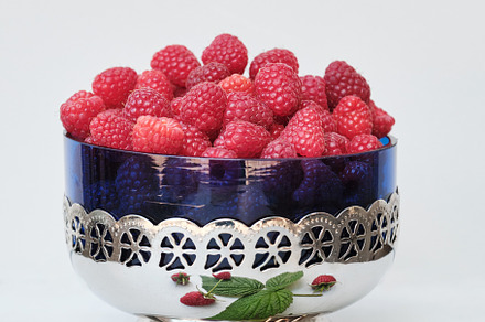 Fresh organic raspberries in a Vintage Glass Bowl with Metal Stand on white bac, a Food & Drink Photo by Rohan Photography
