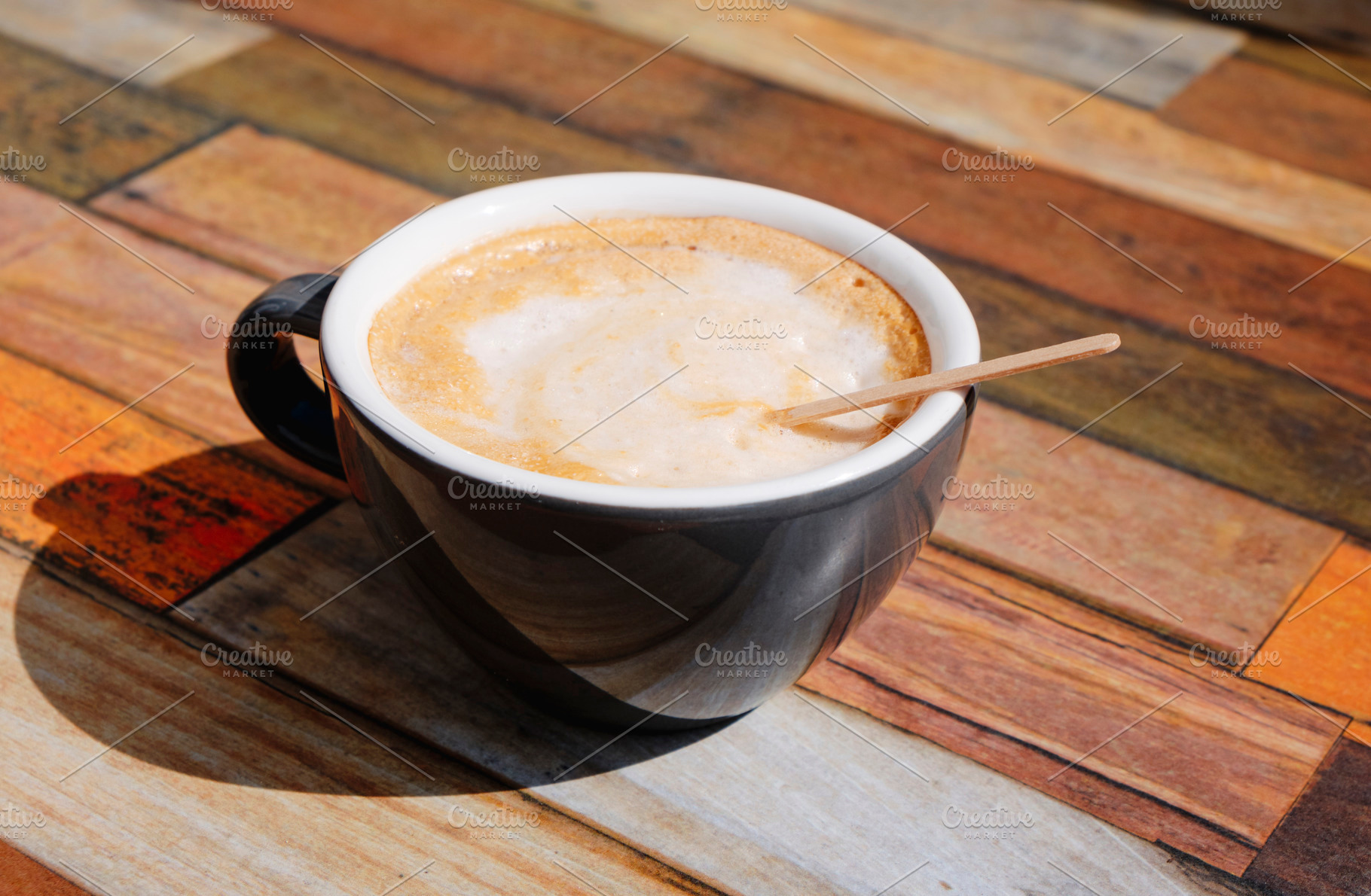 french cafe au lait in a ceramic cup on a table, a Photo by Nito