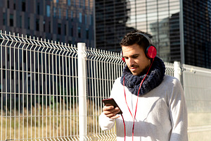 Caucasian man listening to music with smartphone outdoors, a Person Photo by RF Images