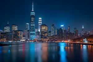 City skyline at night with skyscrape, a Photo by LOGOCREATIVE