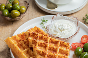 Crunchy waffle fries with sour cream dip served in a basket, a Food & Drink Photo by Budarinphoto