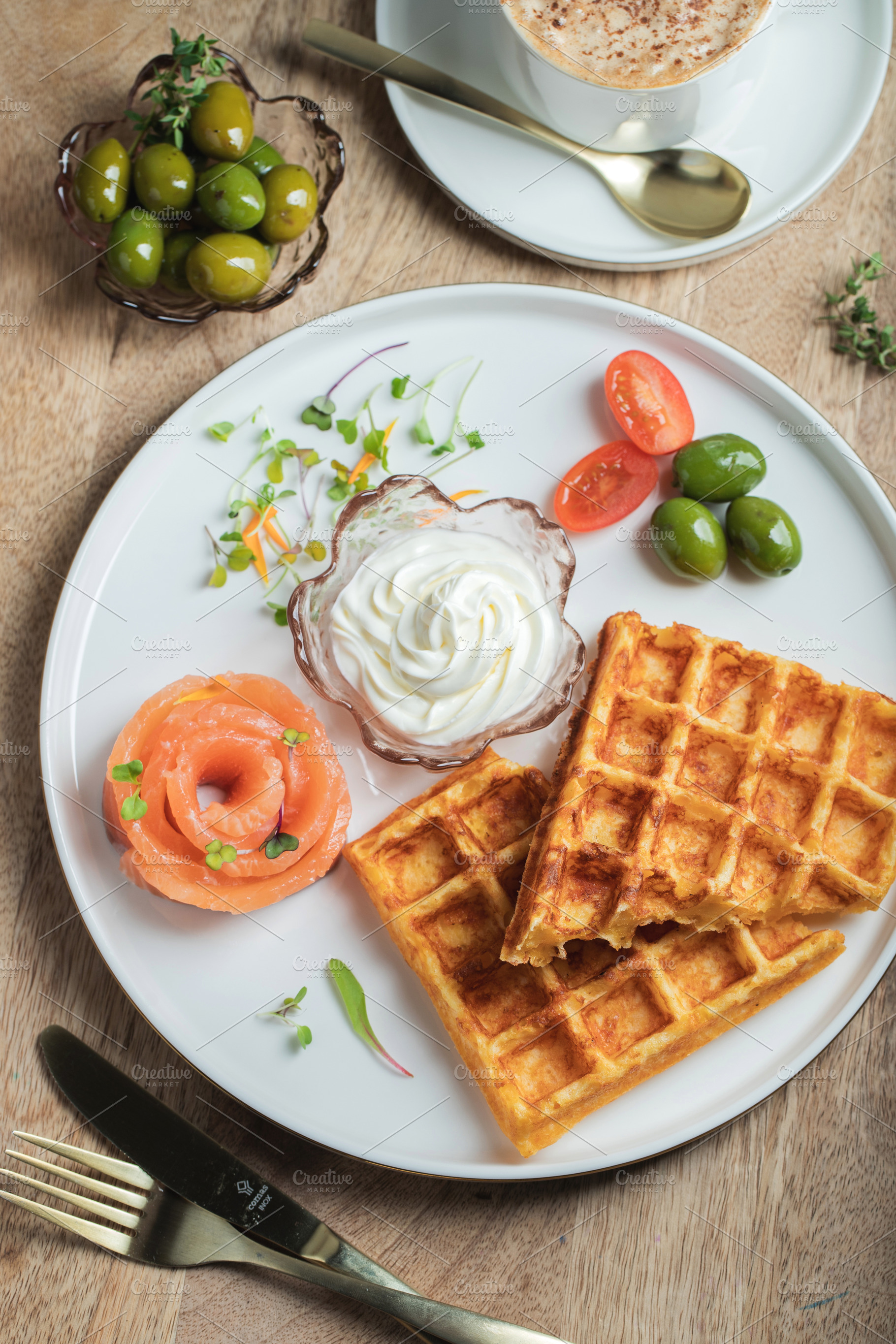 Crunchy waffle fries with sour cream dip served in a basket, a Food & Drink Photo by Budarinphoto