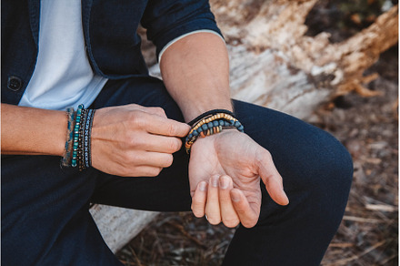 Hands of man with bracelets on both, a Nature Photo by olhovyi_photographer