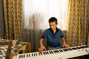 Teen boy in blue polo shirt playing, a Person Photo by Elena Vagengeim