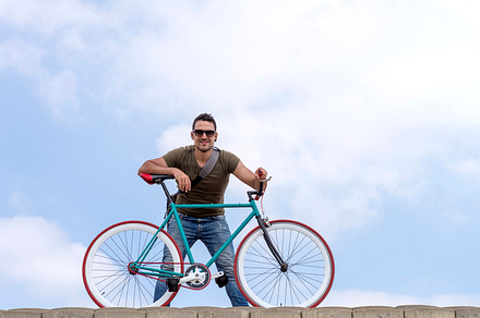 Urban man wearing sunglasses on a cloudscape