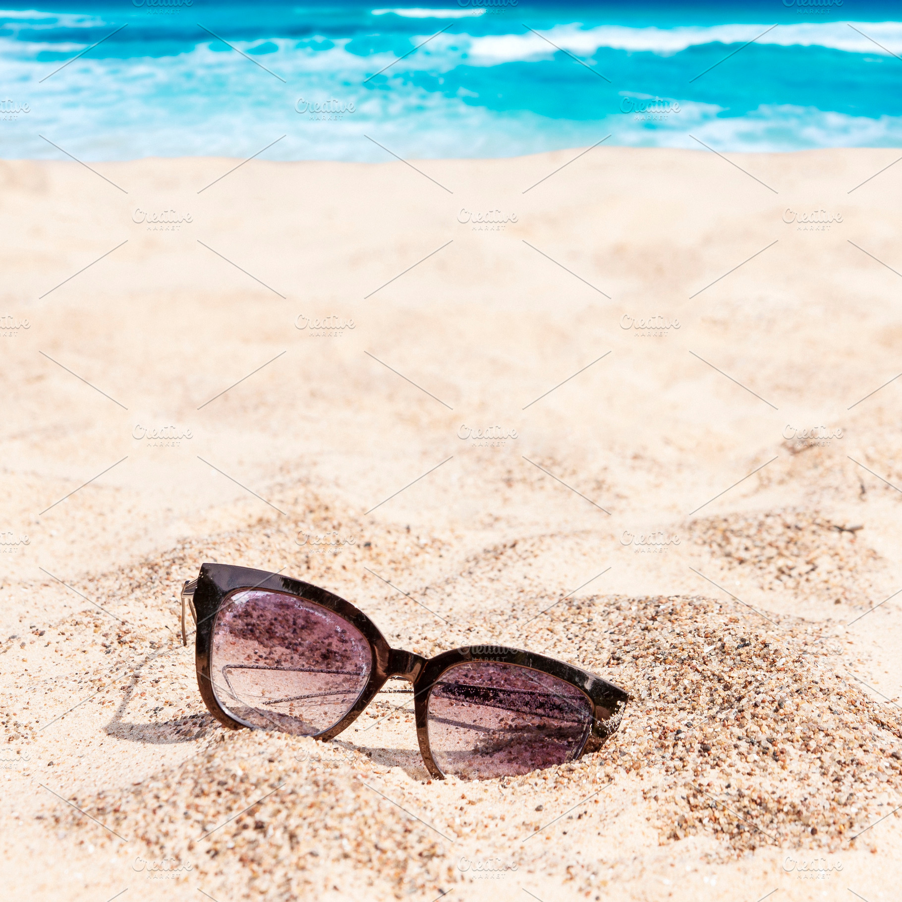 Abandoned sunglasses on the beach, a Beauty & Fashion Photo by BOOCYS