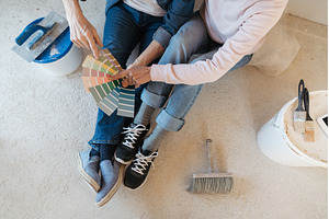 Couple choosing paint colors for, an Industrial Photo by HalfPoint