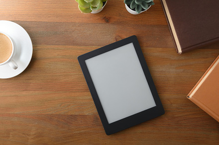 Ebook on wooden table with books and  cup of coffee, a Technology Photo by Davizro's Market
