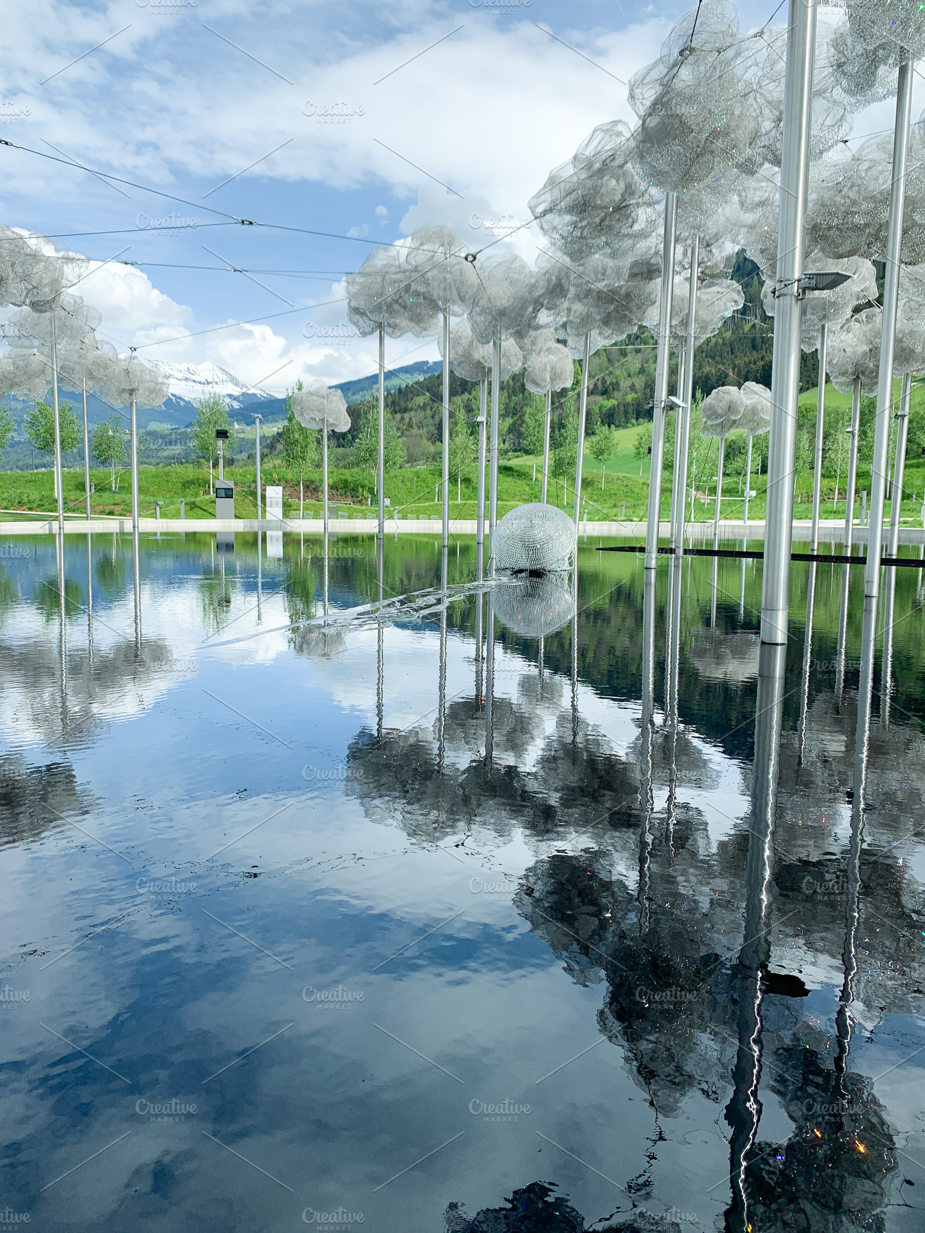 Swarovski museum outdoor installation reflecting on water with s, a Holiday Photo by sebastianaraw