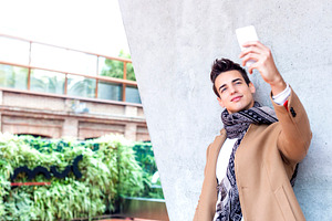 Young man taking selfie outdoors in winter outfit, a Person Photo by RF Images