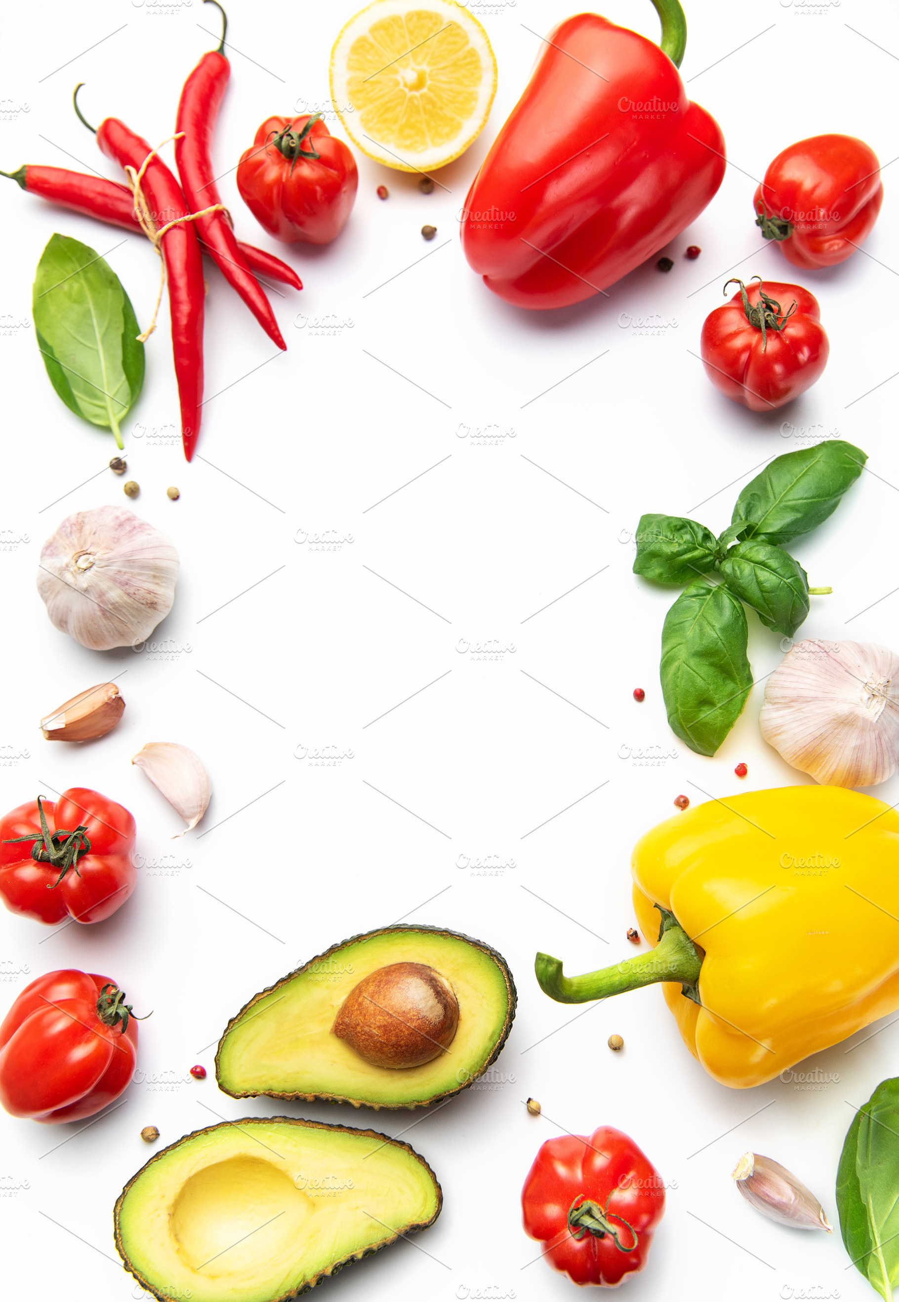 Fresh vegetables and spices creating a border, a Food & Drink Photo by Olena Rudo