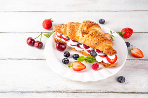 Sweet breakfast croissant sandwich with whipped cream, fresh fru, a Food & Drink Photo by Rimma