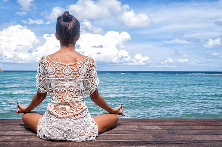 Young beautiful healthy woman making meditation on the beach containing, a Health & Medical Photo by IrinaSS