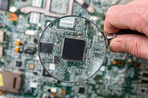 Hand Holding Magnifying Glass Over Microchip, a Technology Photo by Davizro's Market