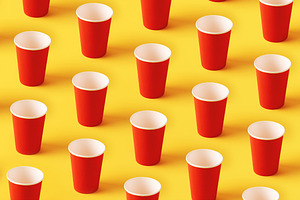 Seamless pattern of upright red cups on a vibrant yellow backgro, a Food & Drink Photo by Ales Munt