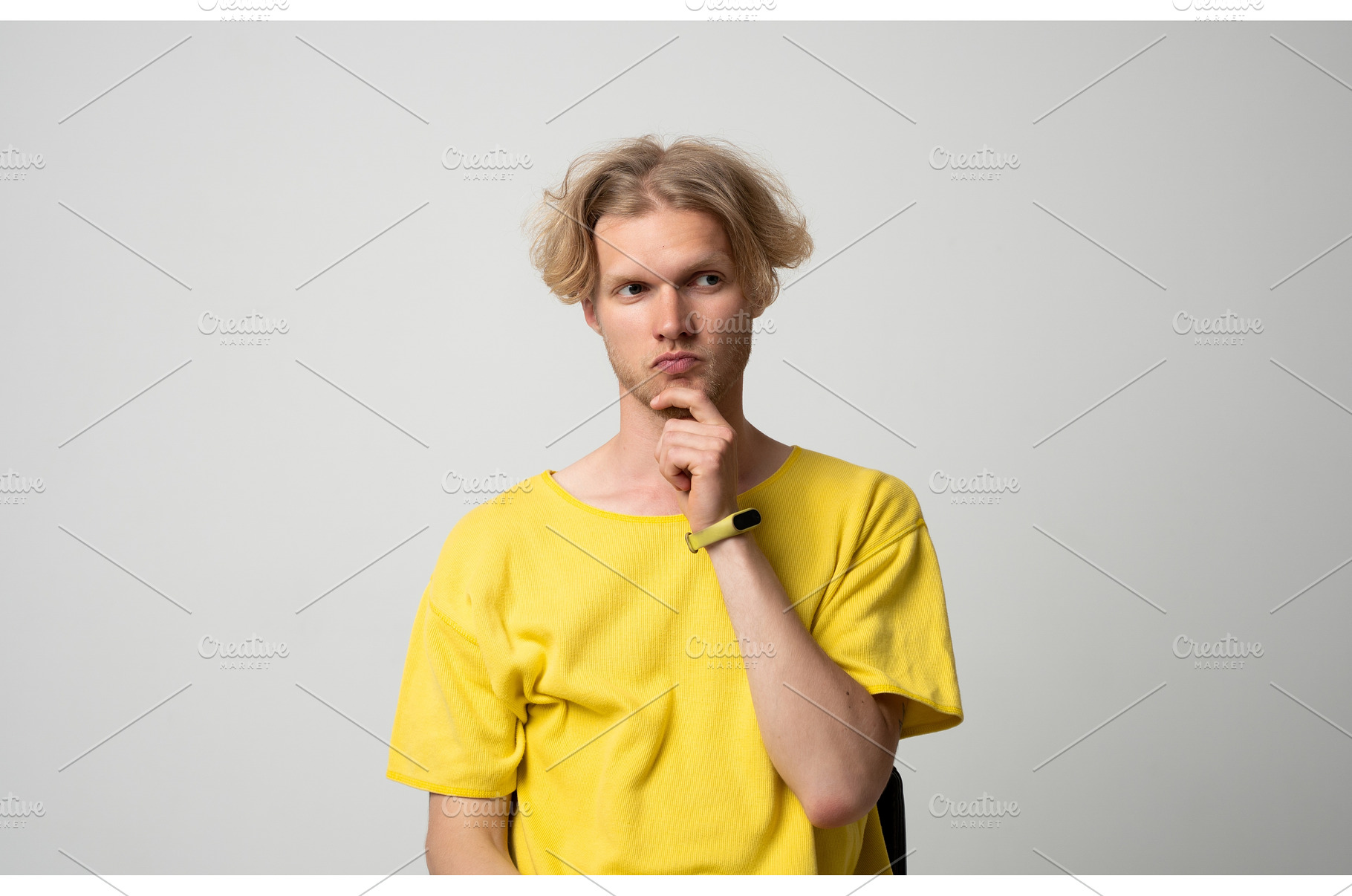 Young man with blond hair in yellow, a Person Photo by volodymyrshtun13795