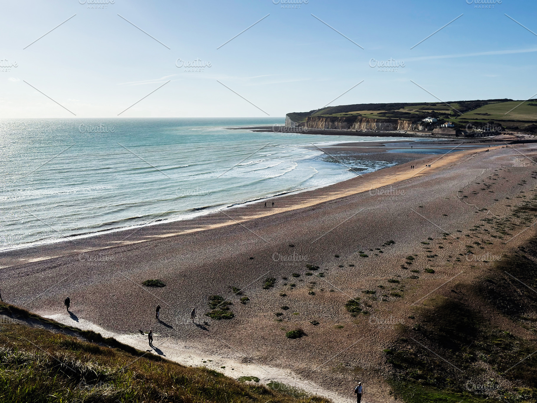 Tranquil coastal scene at Seven Sisters Cliffs in East Sussex with people on th, a Nature Photo by AS photostudio
