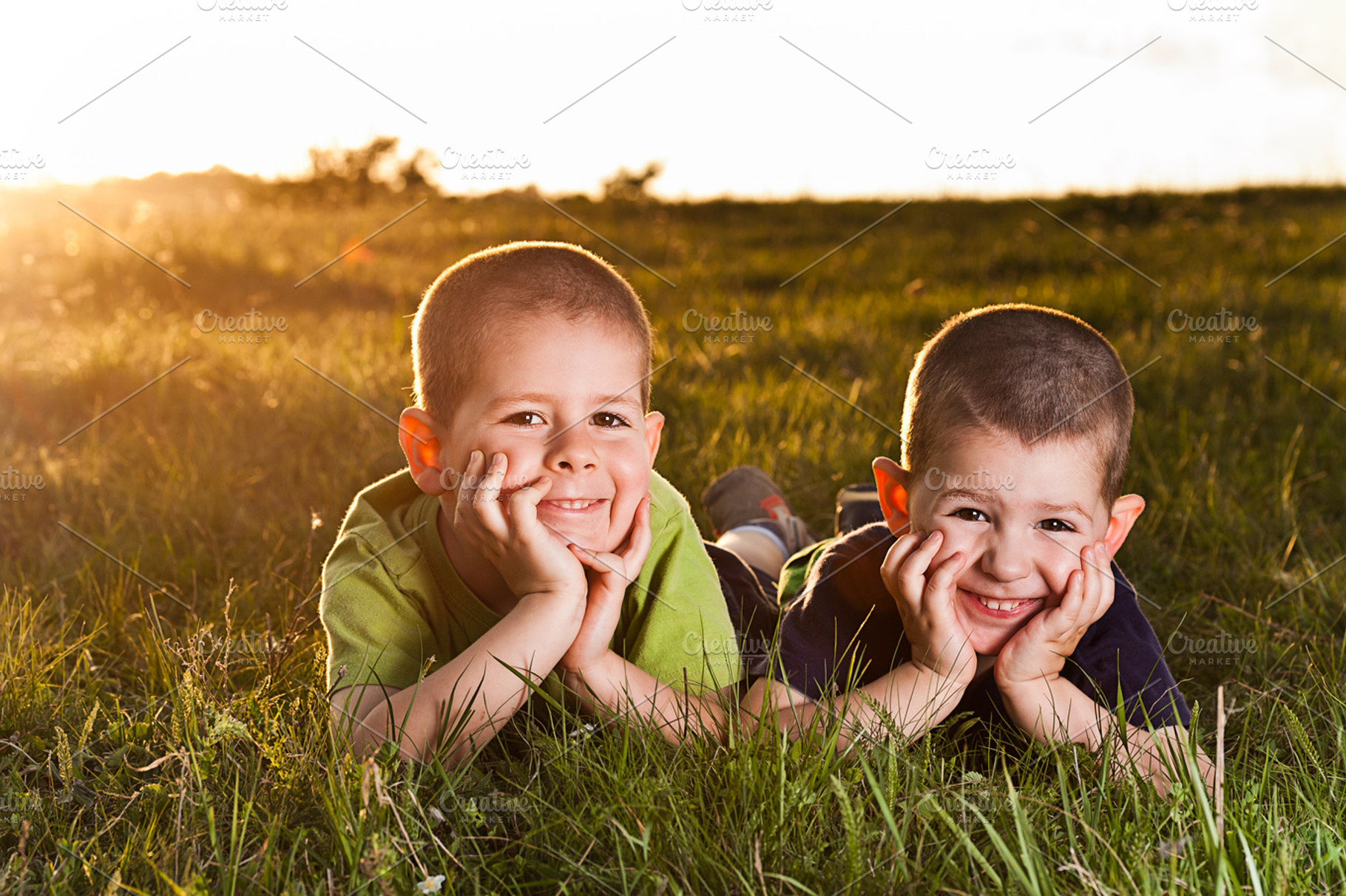 Two brothers lying on grass