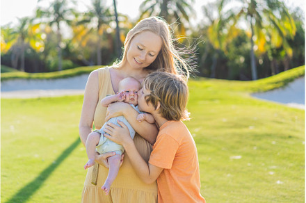 Mother, older son, and newborn baby