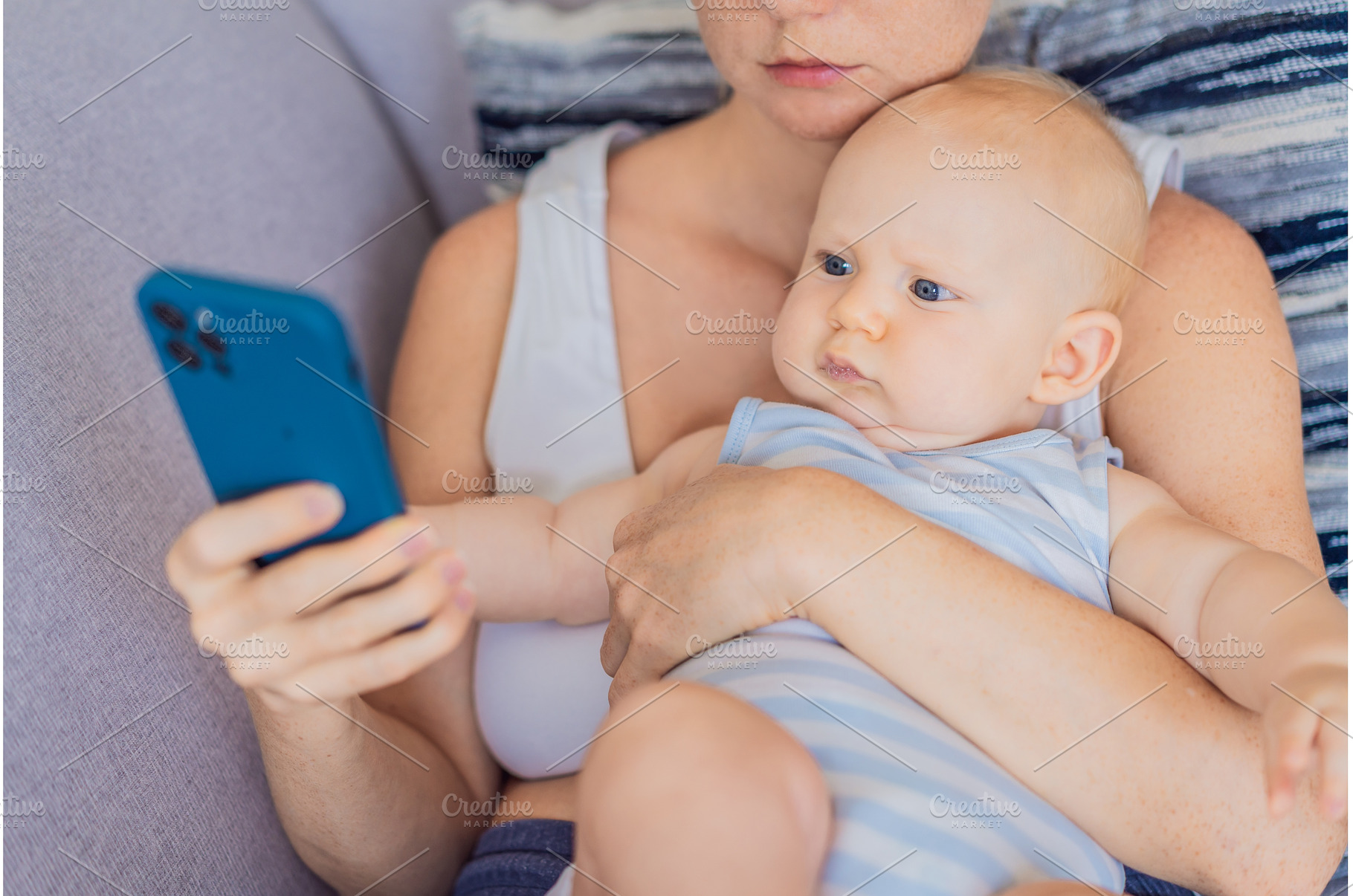 Baby sitting on mother lap while she, a Person Photo by Elizaveta Galitskaya