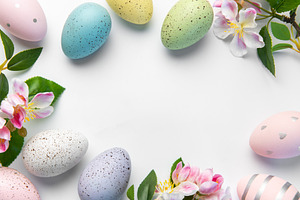 Pastel easter eggs and pink blossoms creating spring border, a Holiday Photo by Olena Rudo