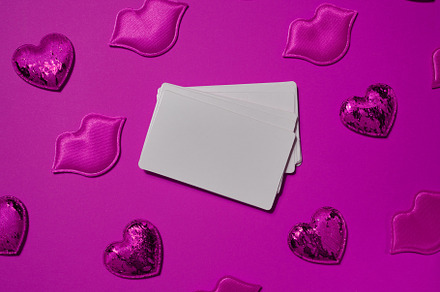 Set of blank white business cards surrounded by pink decorative