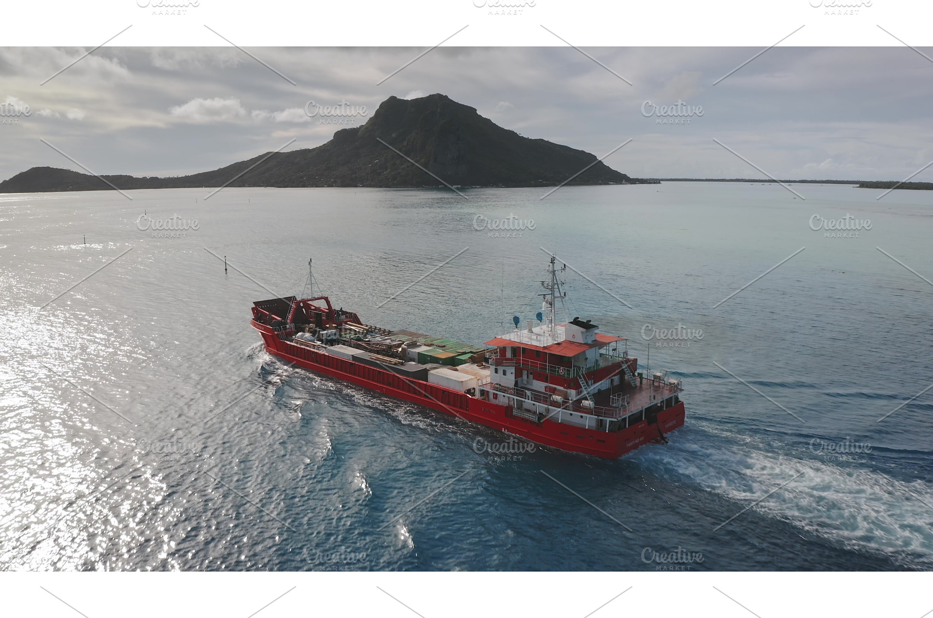 Red cargo ship sailing near tropical, a Nature Photo by Goinyk