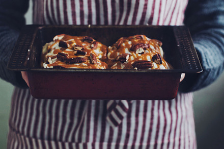 Woman holding cinnamon buns
