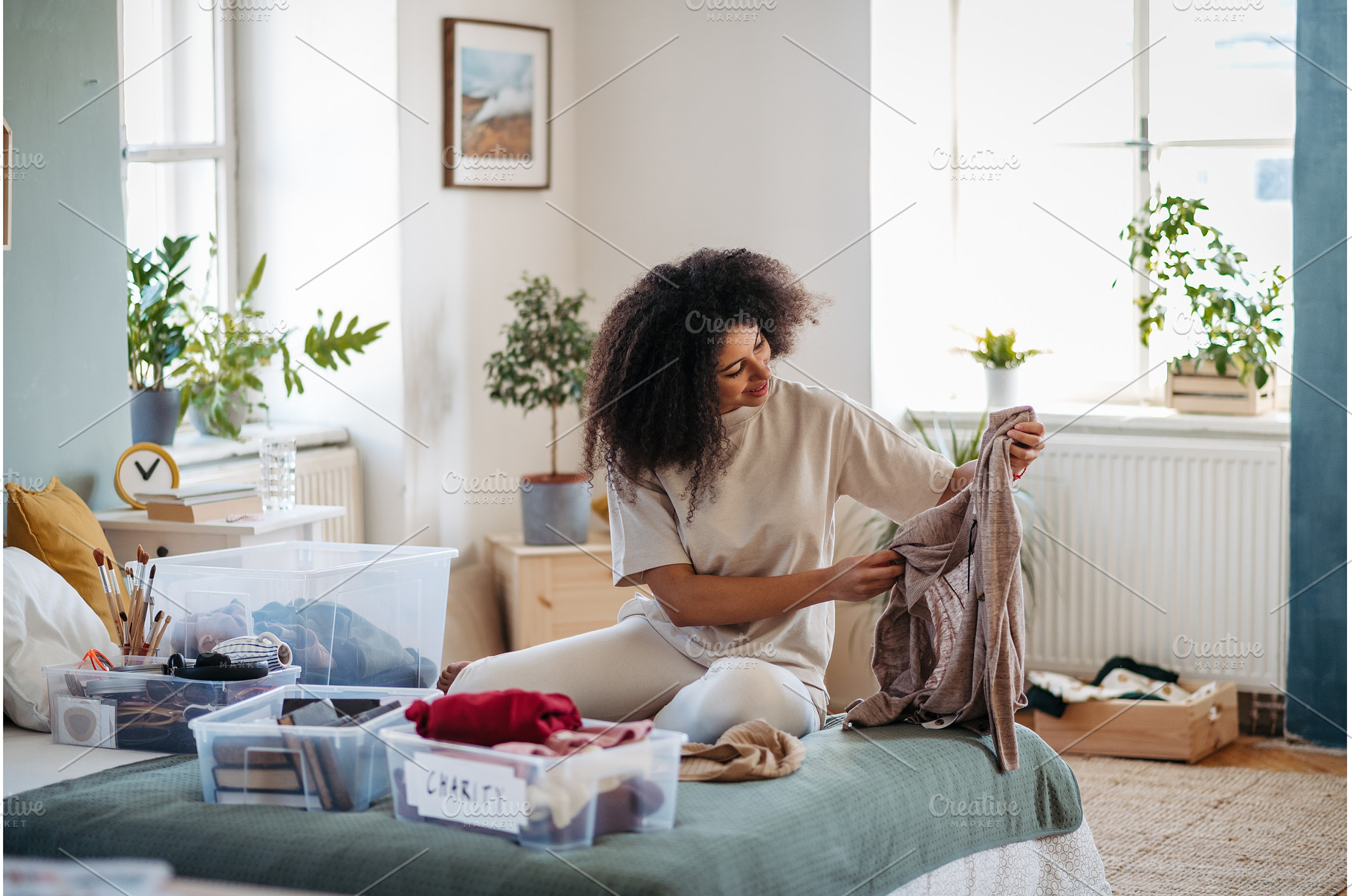 Young woman sorting wardrobe indoors, a Person Photo by HalfPoint